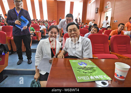 Chinese woman Yang Kexin of Miao ethnic group, the owner of a science museum to introduce meteorite culture, poses for photos with Chinese cosmochemis Stock Photo