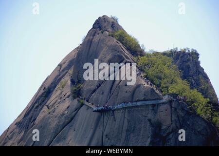 A worm's eye view of a glass walkway along the edge of a cliff at Phoenix Mountain in Dandong city, northeast China's Liaoning province, 9 May 2018. Stock Photo