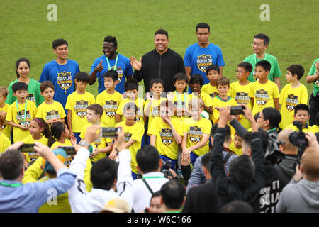 Brazilian football star Ronaldo Luis Nazario de Lima, center, commonly known as Ronaldo, visits one of his soccer schools in Shanghai, China, 20 May 2 Stock Photo