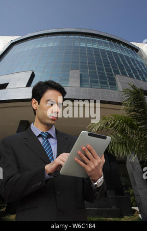 Businessman using a digital tablet Stock Photo