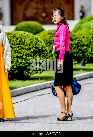 --FILE--A trendy young North Korean woman wearing high heels walks on the street in Pyongyang, North Korea, 29 August 2016. Stock Photo