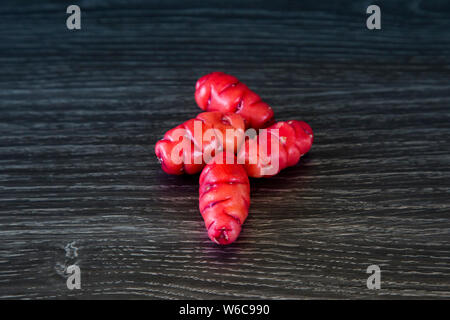 Oxalis tuberosa is also called New Zealand yam. Grown in Andean regions, also called uqa or oca. These are red yams, beautiful bright colour. Stock Photo