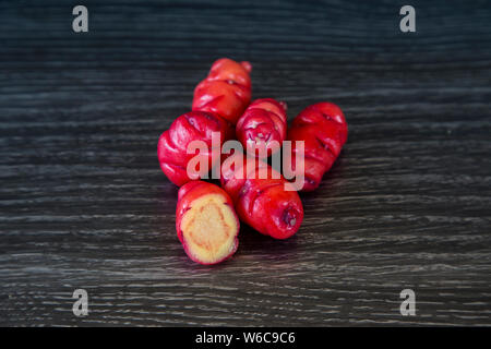 Oxalis tuberosa is also called New Zealand yam. Grown in Andean regions, also called uqa or oca. These are red yams, beautiful bright colour. Stock Photo