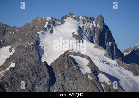 AERIAL VIEW. La Meije summit (elevation: 3983m) in July, viewed from the northeast. La Grave, Hautes-Alpes, France. Stock Photo