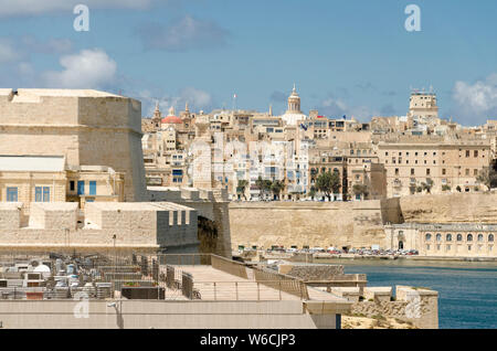 View to Valetta's harbor and old town with a dome of  St. Paul's Pro-Cathedral seen from St. Angelo fort in Vittoriosa, Malta Stock Photo