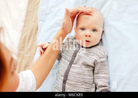 Nurse examining head of cute newborn baby Stock Photo