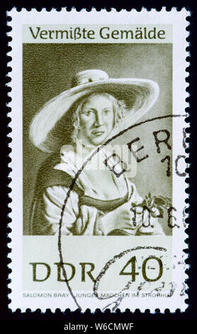 East Germany postage stamp - Young girl in straw hat, S.Bray Stock Photo