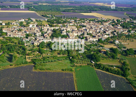AERIAL VIEW. The town of Puimoisson surrounded by lavender fields in July. Valensole Plateau, Provence-Alpes-Côte d'Azur, France. Stock Photo