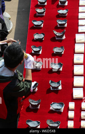 Silver ingots unearthed from the sunken boats owned by peasant leader Zhang Xianzhong (Chang Hsien-chung) of the late Ming dynasty (1368-1644) at the Stock Photo