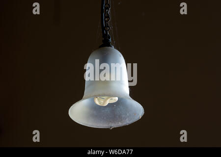 A glass shade with a long-life bulb in a church Stock Photo