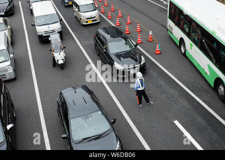 A man managing traffic in Kobe, Hyogo Prefecture, Japan. Stock Photo