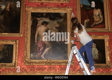 Apsley House, London, UK. 1st August. 'STRICTLY EMBARGOED' UNTIL THURSDAY 1 AUGUST, 12PM.  Technicians arranging  the painting 'Orpheus Enchanting the Animals' goes back on display at Apsley House. An 18-month English Heritage conservation and research project has concluded the painting  thought for more than 100 years to be by Allesandro Varotari  a follower of  Titian is  in fact by Titian’s workshop, in collaboration with the master Credit: amer ghazzal/Alamy Live News Stock Photo