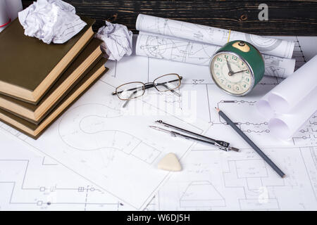 Several tools for drawing, glasses and retro clock lying in the drawings Stock Photo