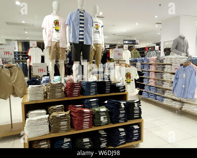 View of anime and manga-themed t-shirts in commemoration with the 50th anniversary of Weekly Shonen Jump for sale at a Uniqlo store in Shanghai, China Stock Photo