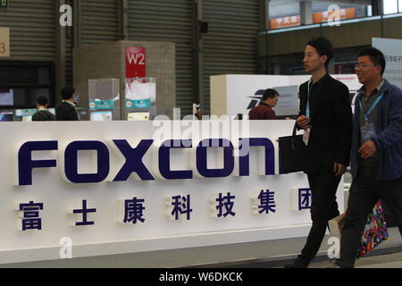 --FILE--Visitors walk past the stand of Foxconn during an exhibition in Shanghai, China, 11 March 2018.   Electronics manufacturing giant Foxconn Tech Stock Photo