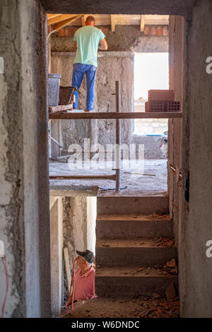 Interior view of men working on the renovation of an old house on the Greek island of Lesvos Stock Photo