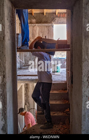 Interior view of men working on the renovation of an old house on the Greek island of Lesvos Stock Photo