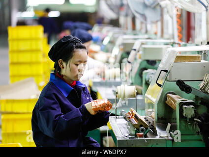 --FILE--Female Chinese workers produce mobile phone parts on the ...