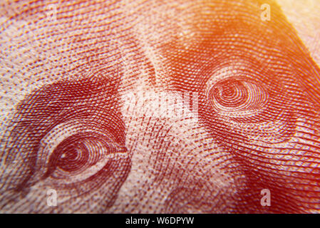 Dolar USA close up. Franklin eyes macro. The texture of the fragment of the dollar bill. USD banknote texture. One hundred American dollars. $ 100. Stock Photo