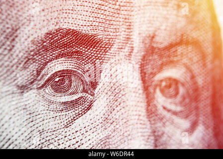 Dolar USA close up. Franklin eyes macro. The texture of the fragment of the dollar bill. USD banknote texture. One hundred American dollars. $ 100. Stock Photo