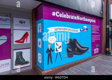 Northampton, U.K. 1st August 2019. Northampton's rich shoe heritage is being celebrated with the first giant shoe sculpture trail throughout the town centre. The first shoe sculptures made of fibre glass, a red stiletto, is in place on the Market Square. More sculptures are to follow through out August, the 12 shoe sculptures are of giant stilettos, brogues, Doc Martens and Chelsea boots designed and created by Noel Blakeman Ltd. Credit: Keith J Smith./Alamy Live News Stock Photo