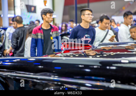 --FILE--Visitors look at Red Flag or Hongqi cars is on display during the 15th China (Guangzhou) International Automobile Exhibition, also known as Au Stock Photo