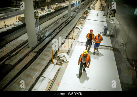 Berlin, Germany. 01st Aug, 2019. Construction workers walk on a construction site on a future platform of the subway line U5 at the U5 info station in front of the Rotes Rathaus. Credit: Carsten Koall/dpa/Alamy Live News Stock Photo