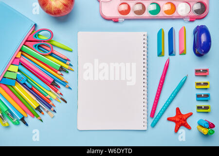 Bright composition from the stationery on a blue background Stock Photo