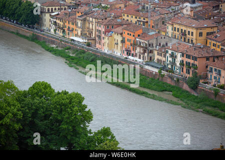 A loop of the River Adige contains the ancient city of Verona, a UNESCO World Heritage Site, in Italy. Via Ponte Pietro houses have backs by the Adige Stock Photo