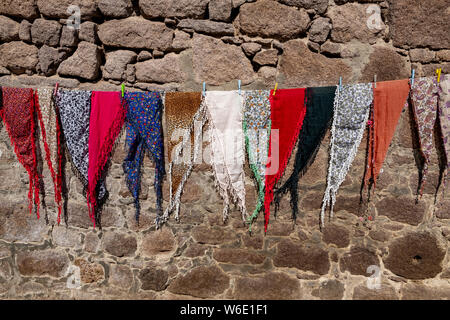 Colorful scarves for sale hanging on a clothesline at a shop in rural Turkey Stock Photo