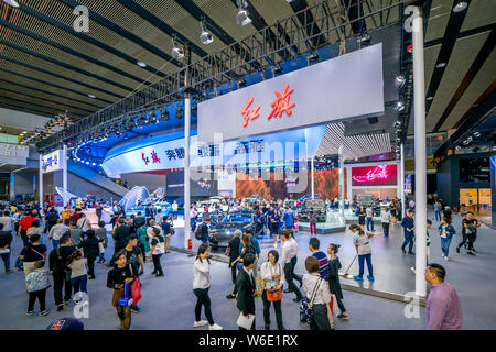 --FILE--Visitors look at Red Flag or Hongqi cars is on display during the 15th China (Guangzhou) International Automobile Exhibition, also known as Au Stock Photo