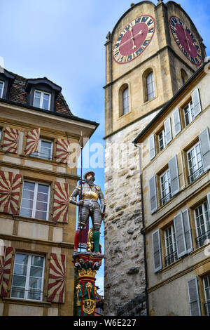 Switzerland: Neuchatel. Typical apartment building in the city center and restored Banneret (“Banner Carrier”, the local militia chief) Fountain with Stock Photo