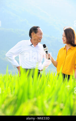 Chinese agricultural scientist and educator Yuan Longping, left, known for developing the first hybrid rice varieties in the 1970s, is interviewed by