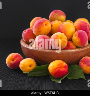 Organic apricots in a wooden bowl Stock Photo