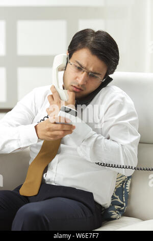 Man Using Many Phones Man using multiple mobile phones Stock Photo - Alamy