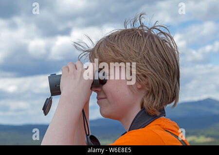 boy looking through binoculars, Neuschönau, National Park, Bayerischer Wald, Bavaria, Germany Stock Photo