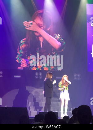 South Korean singer and dancer Kim Hyun-ah, better known by the mononym Hyuna, stylized as HyunA, right, weeps as she is touched by fans during a fan Stock Photo