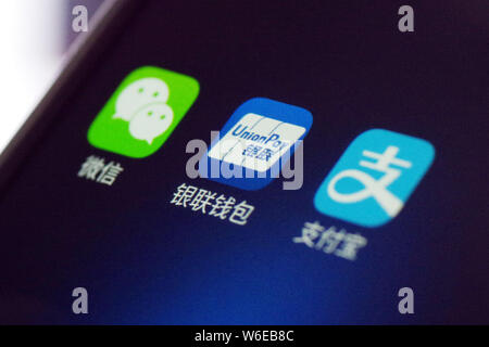 --FILE--A Chinese mobile phone user shows the icons of the mobile apps (from left) messaging app Weixin, or WeChat, of Tencent, mobile wallet UnionPay Stock Photo