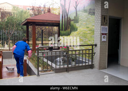 --FILE--A Chinese worker cleans a public toilet in Shanghai, China, 4 December 2017.    A district urban management authority in Wuhan, Hubei province Stock Photo