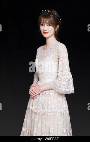 Chinese actress Qiao Xin, also known as Bridgette Qiao, poses for portrait photos during an exclusive interview by Imaginechina in Beijing, China, 17 Stock Photo