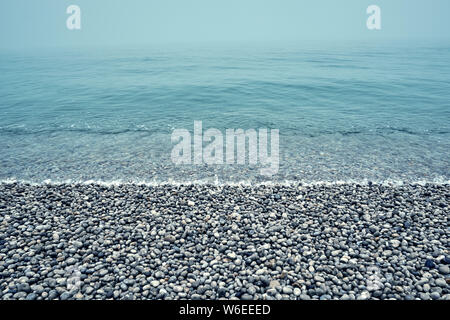 Pebble stones on a sea shore background. Stock Photo