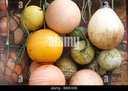 Old dirty, faded, weathered fishing buoys, floats, hanging on a net. fishing concept Stock Photo