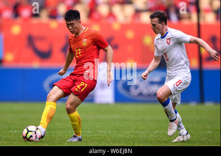 Deng Hanwen, left, of Chinese national men's football team kicks the ball to make a pass against Vladimir Darida of Czech Republic national football t Stock Photo