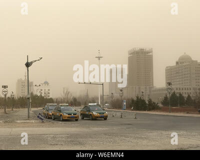Cars drive on a road in a sandstorm in Xilinhot city, north China's Inner Mongolia Autonomous Region, 27 March 2018.   A huge sandstorm swept through Stock Photo