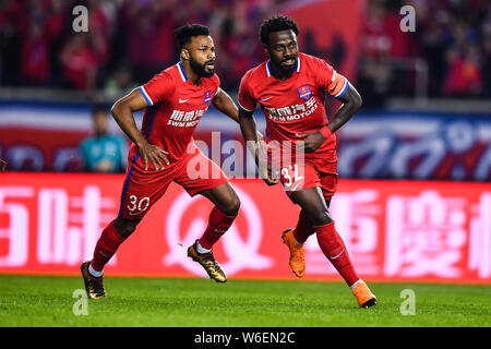 Brazilian football player Fernandinho Henrique of Chongqing SWM, right, celebrates with his teammate Brazilian football player Luiz Fernandinho after Stock Photo