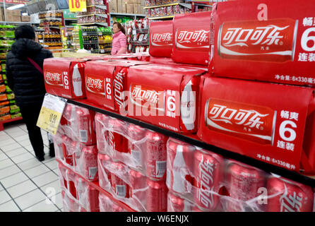 --FILE--Tins of Coca-Cola coke are seen for sale at a supermarket in Shanghai, China, 22 March 2018.   Coca-Cola Co. has raised the price of its iconi Stock Photo