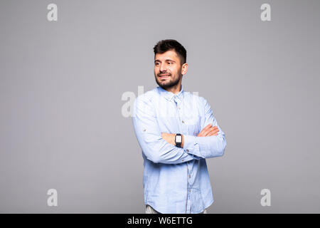 Portrait cool man having his arms crossed, looking at camera, isolated on grey background Stock Photo