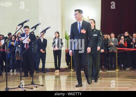 Pony Ma Huateng, front, Chairman and CEO of Tencent Holdings Ltd., is interviewed as he arrives at the 'deputy passage' before the opening meeting for Stock Photo