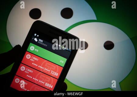 --FILE--A Chinese mobile phone user shows the mobile app messaging app Weixin, or WeChat, of Tencent, binding with his bank cards in Zhengzhou city, c Stock Photo