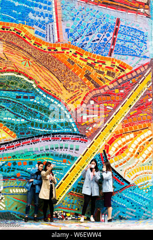 Visitors take photos in front of the colorful exterior facade of the Chongqing Luo Zhongli Art Museum on the Huxi Campus of Sichuan Fine Arts Institut Stock Photo